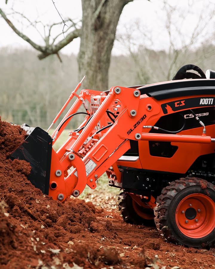 Red Kioti CK Series Compact Tractor with front loader working in a Northern Virginia field